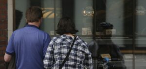 man and woman gazing through Baytown commercial glass storefront