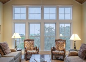 Living room with brown furniture and large windows that had window repair services