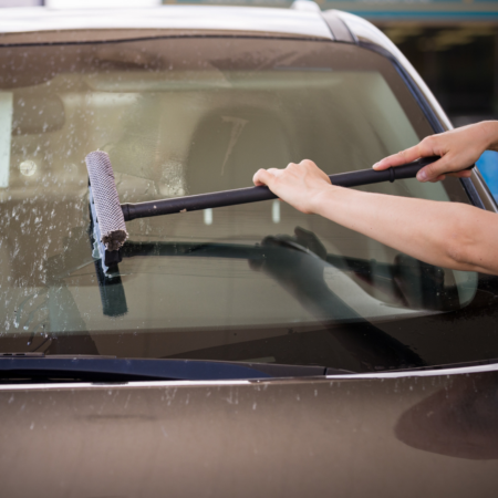person deciding between an aftermarket windshield replacement and OEM auto glass services